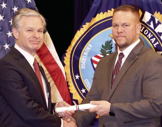 SBSO Maj. Daniel Bostic, right, receives his diploma from FBI Director Christopher Wray upon graduating from the FBI National Academy.
