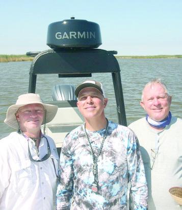 Rob Sporl Jr., fishing guide Davey Miles, and Rob Sporl fishing on the eastbank of the Mississippi River.