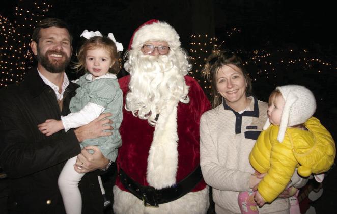 A new family to St. Bernard, the Trent Moss family with Santa at the Torres Park celebration.