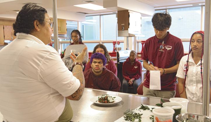 Chef Melissa Araujo demonstrates plating techniques, told stories of her cooking journey, and shared delicious bites to Chalmette High School students.
