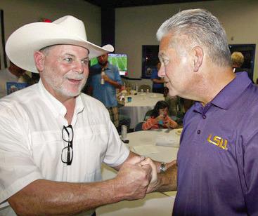 Two old friends... Jimmy Pohlmann has a congratulations hand shake with Louie Pomes.
