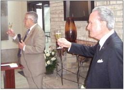Pete Matthews, a longtime friend of Roberta and Sidney, lifts his glass in a champagne toast to Roberta.