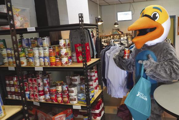 Bernard the Pelican, Nunez Community College’s mascot, browses the shelves in the Pelican Care Corner on the Nunez campus. The Pelican Care Corner recently earned Nunez its third consecutive Outstanding Program or Practice of the Year Award for 2-year institutions from the Louisiana Association of College &amp; University Student Personnel Administrators (LACUSPA).