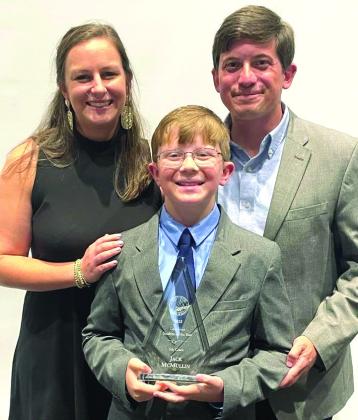Jack McMullin (center) poses with mom Meaghan McMullin (left) and dad Jeremy McMullin for a photo after winning Elementary School Student of the Year.