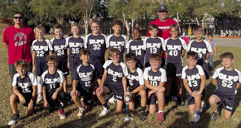 Members of the Our Lady of Prompt Succor Junior Flag Football team are shown. Back row, from left: Coach Dirck Duncan, Jase Fazzio, Talan Chilton, Michael Warden, Landon Pichon, Christian Fernandez, Alton Brown, Jack Bazile, Colby Barnes, Avery Sanchez, and Coach Terry Christoffer, standing behind the boys on the right. Front row, from left: Roy Lally, Travis Guillot, Colby Duncan, Beckett Christoffer, Clay Carlin, Chad Stechmann, Gabriel Roques, and Kaiden Riche.