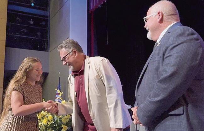 Meraux Foundation Board Members Bill Haines and Chris Haines present scholarship awards to 70 graduating seniors at Chalmette High School during a ceremony on April 15.