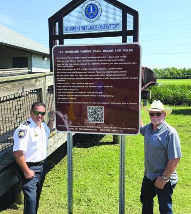 Col. Chad Clark, commander of the SBSO Criminal Investigations Bureau, left, and Parish President Louis Pomes stand beside a new trail safety sign installed through a partnership between SBSO and SBPG to enhance safety along the parish’s bikeway and trail system. The initiative also includes the installation of more than a dozen surveillance cameras along the trails.