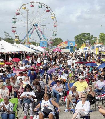 Louisiana Crawfish Festival crowd gathers before the main stage for a live music performance.