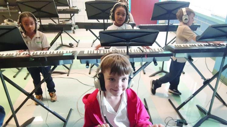 Music students from Arabi Elementary using their new headphones.