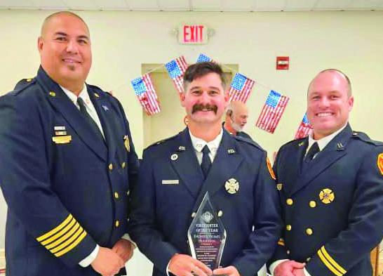 Pictured, from left: Fire Chief Earl Borden Jr., Michael Henderson and Captain Justin Sager.