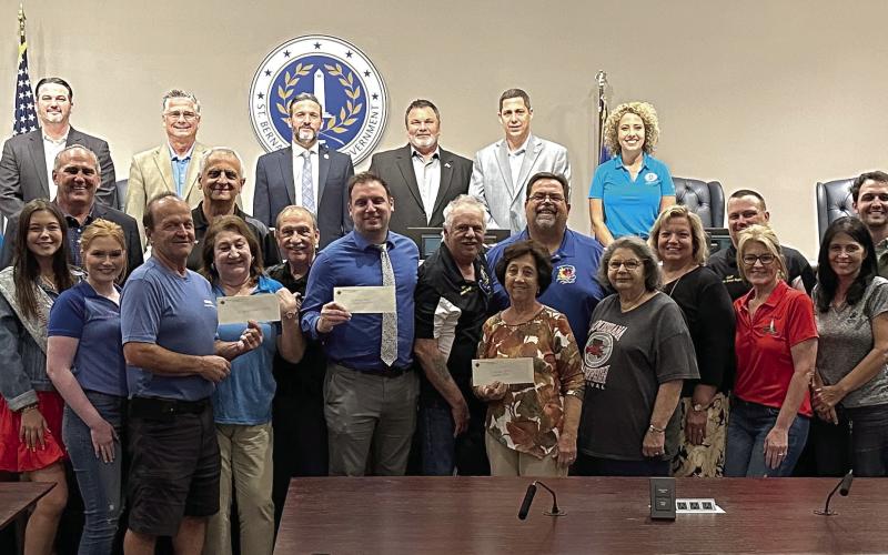 St. Bernard Parish Council and Parish President Guy McInnis accept check donations from the Knights of Columbus's Archbishop Rummel Council #5747.