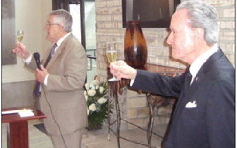 Pete Matthews, a longtime friend of Roberta and Sidney, lifts his glass in a champagne toast to Roberta.