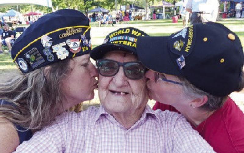 What more could at 96-year-old WWII veteran want but two ladies giving him a kiss and saying thank you for his service.