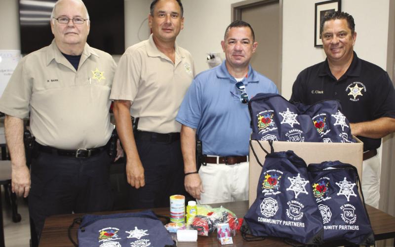 From left, are: Capt. Richard Barr and Lt. Leander Morgan of the Field Operations Bureau Patrol Division; Sgt. Jerey Vega, a detective with the Criminal Investigations Bureau and Autism Krewe board member; and Col. Chad Clark, commander of the Criminal Investigations Bureau.