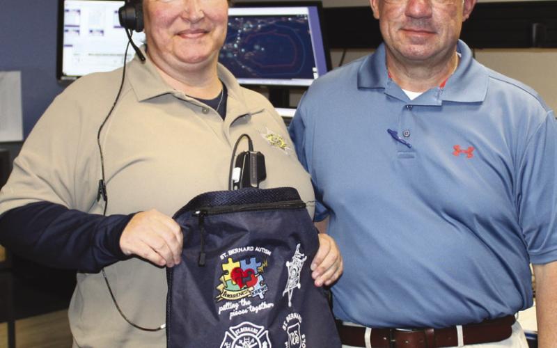 Dep. Angela Skyles, of SBSO's Communications Division 9-1-1 Center, left, accepts a sensory bag from SBSO Sgt. Jerey Vega.