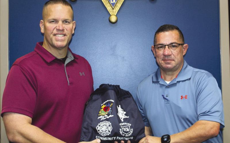 Col. Daniel Bostic, commander of SBSO's Special Investigations Division, left, accepts a sensory bag from SBSO Sgt. Jerey Vega.