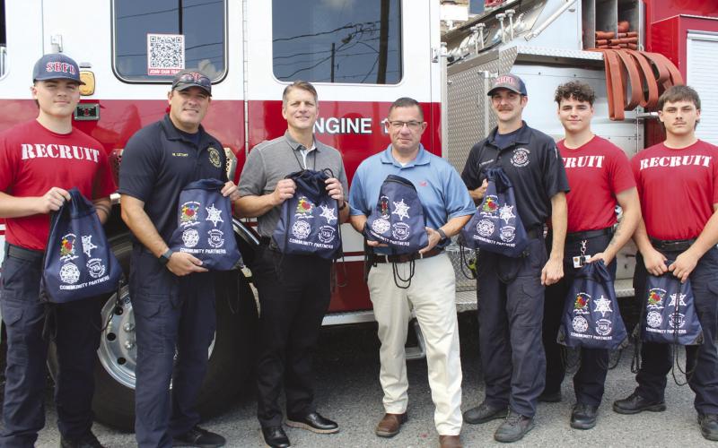 SBSO Sgt. Jerey Vega with St. Bernard Parish Fire Department firefighters as they receive sensory bags. From left, are: Firefighter Recruit Hunter Brockhaus, Capt. Wayne Letort, Assistant Fire Chief Charles Licciardi, Engineer Dan Fernandez, Firefighter Recruit Christian Broadbridge, and Firefighter Recruit Oakley Fischer.