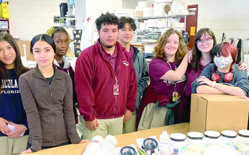 CHS Art students help Lynne Lincoln and Jeannie Bacon sort through specialty supplies donated by MS Rau.