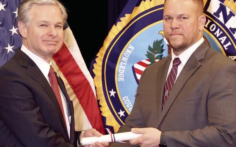 SBSO Maj. Daniel Bostic, right, receives his diploma from FBI Director Christopher Wray upon graduating from the FBI National Academy.