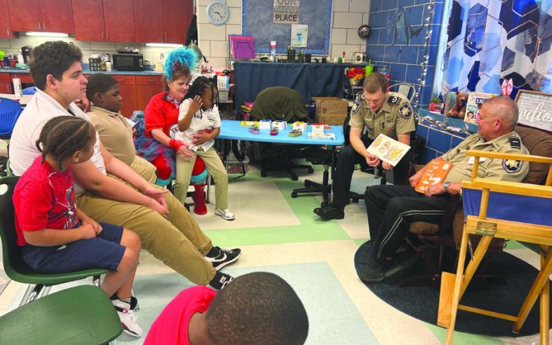 Lt. Eric Eilers of SBSO’s Community Relations Division, right, and Chaplain Dep.Aaron Johnson spent time with Arabi Elementary students during the school’s Literacy Week festivities.