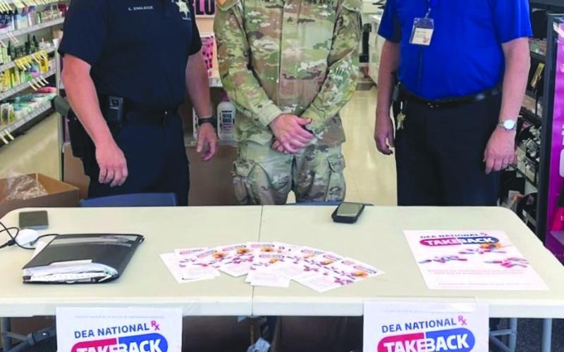 From left: Special Investigations Division Narcotics Agent Lt. Cli ord "Chip" Englande, Sgt. Barry Sevin with the National Guard Counter Drug Program, and Walgreens Manager Kevin Krul.