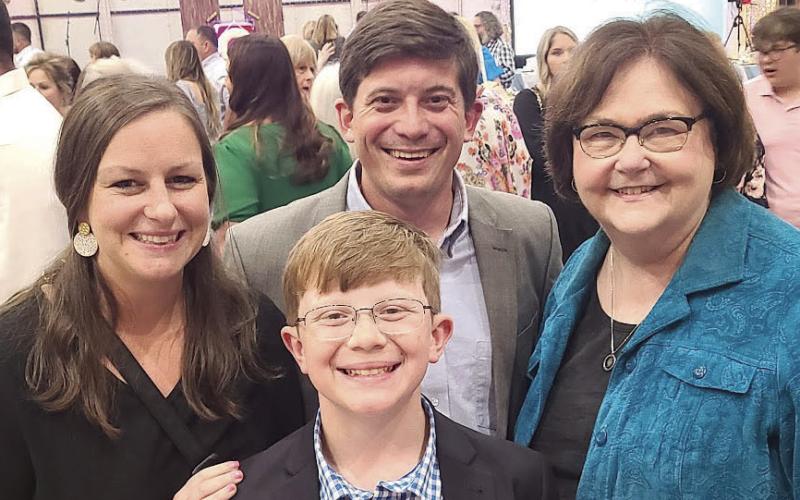 District Elementary Student of the Year Jack McMullin poses for a picture with his parents and Superintendent Doris Voitier.