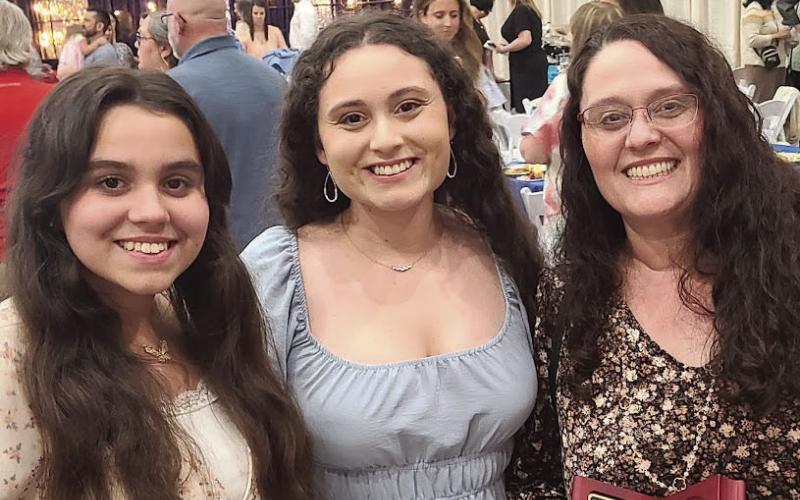 Dana Wilson, a parent with two children in the public school system, was honored by her daughter Catherine (center) as one of the Parents of the Year.