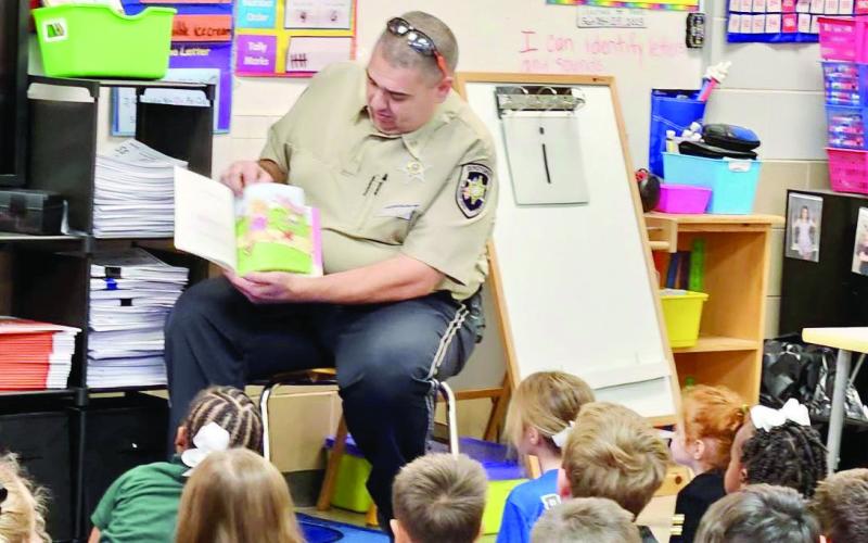 SBSO Corrections Division Dep. Anthony Arnona reads to Davies students.