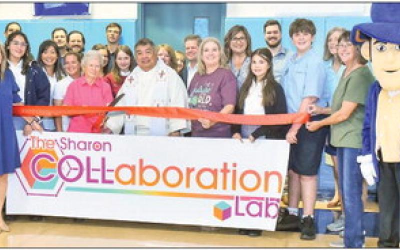 Our Lady of Prompt Succor teachers and students at the ribbon cutting for the school’s Collaboration Lab.