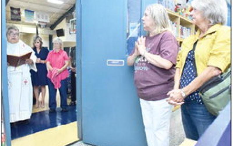 The Rev. Marlon Mangubat, pastor of Our Lady of Prompt Succor Church, blesses the Collaboration Lab.