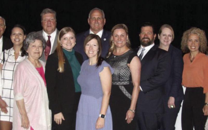 Members of the St. Bernard Chamber of Commerce and local government officials pose for a photo after the State of the Parish presentations.