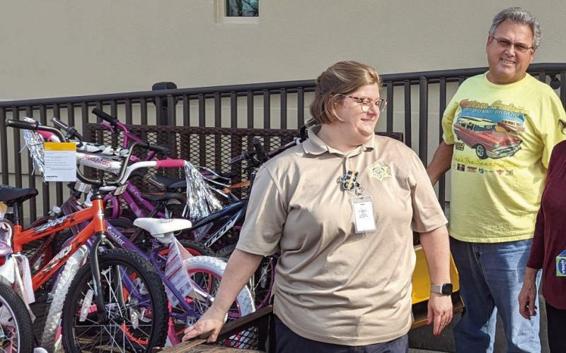 The Custom Cruisers Car Club recently donated toys and bicycles to the St. Bernard Sheriff’s Office (SBSO) COPS. COPS (Caring Officers Provide Smiles) is a Christmas program that helps needy families by providing things such as toys, Christmas trees, food, clothing, and household items. Pictured, from left: Lt. Lacye Lulei of SBSO’s Communications Division, and David Larsen and Pam Larter of the Custom Cruisers Car Club.