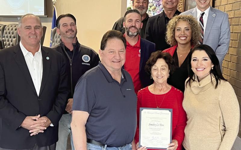 St. Bernard Parish Government Council Members and Parish President Guy McInnis pose for a photo at the Dec.19 Council meeting with the owners of Smitty’s Tire after officially recognizing the company for its 50 years of operations in the parish.