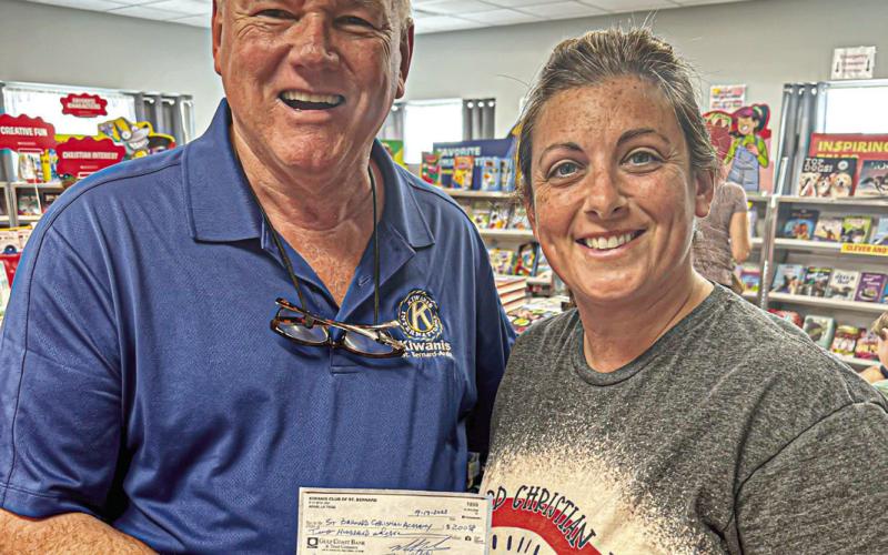 Pictured, from left: Michael B. Chutz of Kiwanis and Jodie Rogers, the School Librarian of St. Bernard Christian Academy.