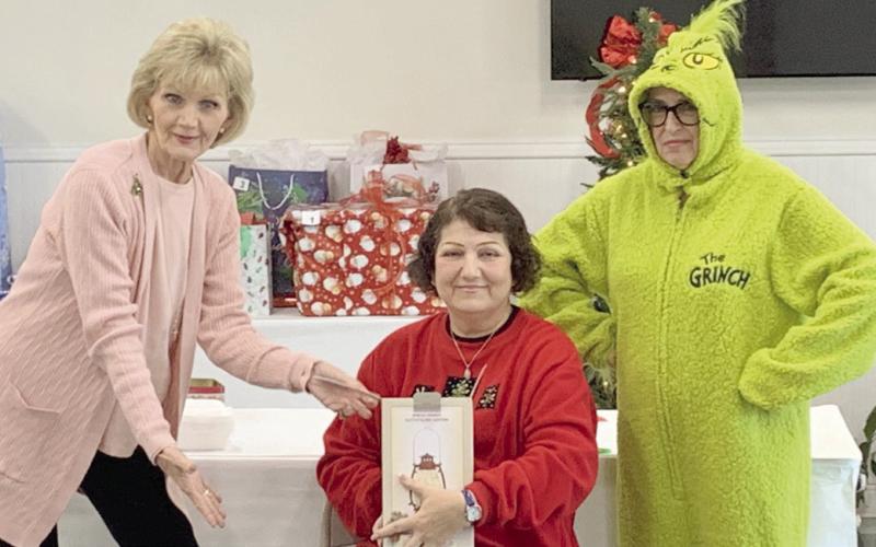 Pictured, from left: Carol Ludwig, Carol Eilers, and Joan Garofalo as the Grinch.