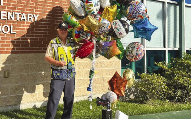 Richard Piergalski and his balloons given to him by his Arabi Elementary School family to show their appreciation.