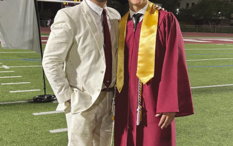 Jackson Nunez, who in addition to graduating at the top of his class was also honored with the American Legion Award. Here he is being congratulated by principal and fellow Owl Will Schneider.