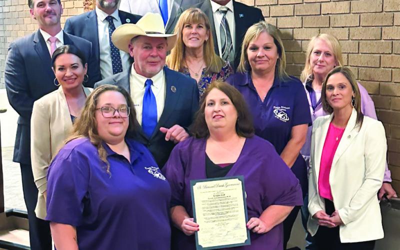 Parish council members and parish president Louis Pomes pose for photo alongside members of the Family Violence Program in St. Bernard after proclaiming the month of October as Domestic Violence Awareness Month in the parish.