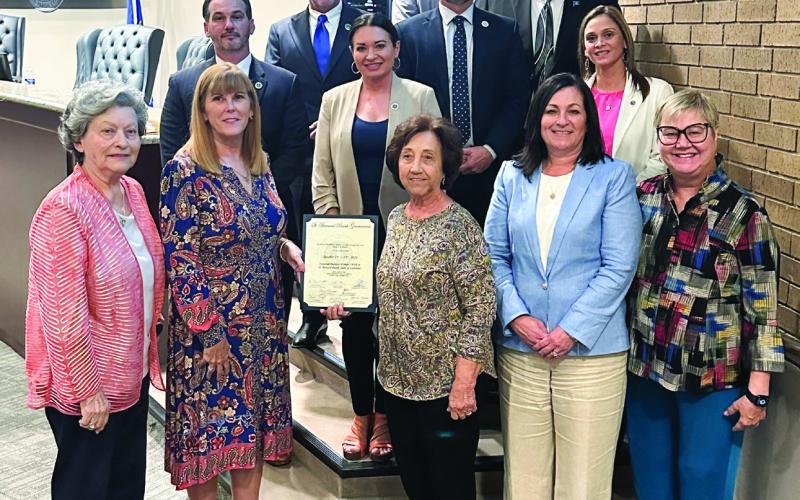 The parish council and parish president Louis Pomes pose for a photo with former council member Wanda Alcon and other members of the St. Bernard Business and Professional Women's Club after proclaiming October 21 through October 25 as National Business Women's Week in the parish.