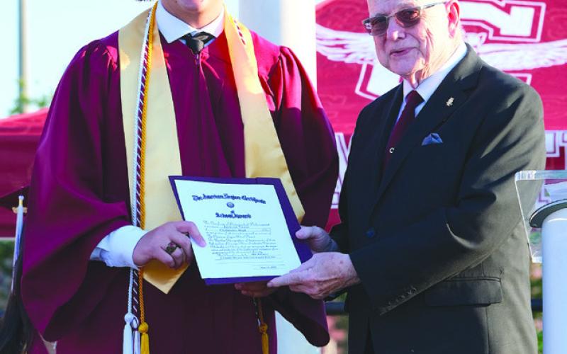 Principal Emeritus Wayne Warner presents American Legion Award to Jackson Nunez.