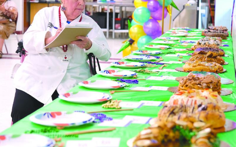 Chef Ruth scoring the category of presentation during the 32nd Annual King Cake Extravaganza.