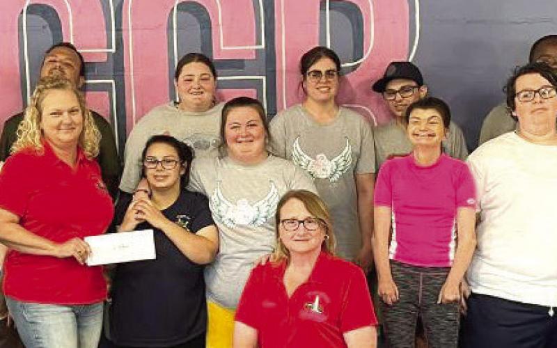 The League of Angels received a donation from the Rummel Ladies Auxiliary, a women's association with the Knights of Columbus Archbishop Rummel Council #5747 in Chalmette; on Thursday, April 13 during their Angels Gone Buff Class. Representing the Auxiliary [in red] is Bertha Gutierrez (left), Denise Ricouard (center) and Virginia Randazzo (right).