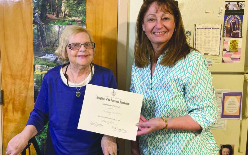 Francois deLery Chapter, Daughters of the American Revolution, past Regent Gayle Buckley (R) recently presented former Chaplain Christine Morrison (L) with a certificate and pin for Excellence in Community Service. Christine hosts poetry writing sessions at her assisted living facility and does online work with the Franciscans. Christine is a former resident of Chalmette.
