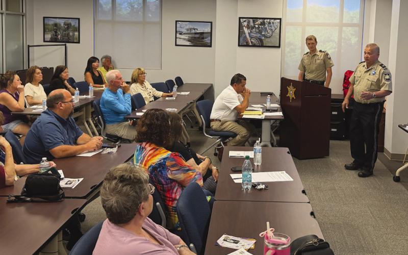 Lt. Eric Eilers, right, and Chaplain Dep. Aaron Johnson provided attendees with practical safety tips and strategies to reduce their risk of becoming a victim during the St. Bernard Sheri 's O ce "Refuse To Be A Victim” class.