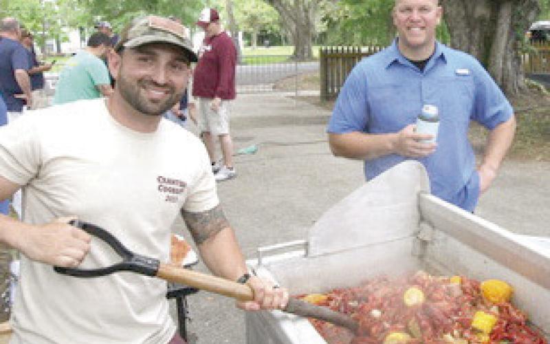 The best job is stirring the pot of delicious hot crawdads.