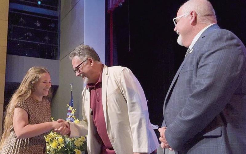 Meraux Foundation Board Members Bill Haines and Chris Haines present scholarship awards to 70 graduating seniors at Chalmette High School during a ceremony on April 15.