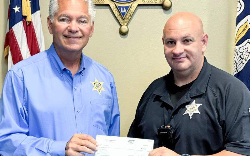 (Left to right) Sheriff James Pohlmann awards Detective Thomas Gai with 2024 Louisiana Fraternal Order of Police Scholarship.