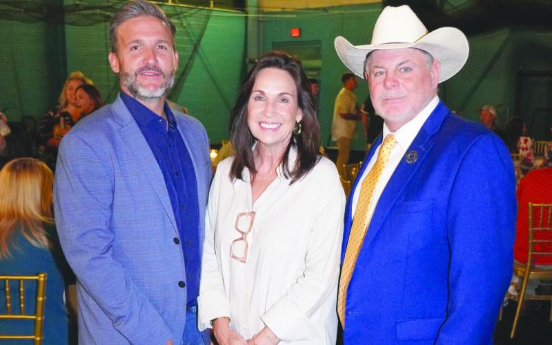 Dr. Tina Tinney, Nunez Chancellor, center, enjoys the 2025 Summer Baseball Bash alongside St. Bernard Parish President Louis Pomes, right, and District B Council Member Josh Moran, left.