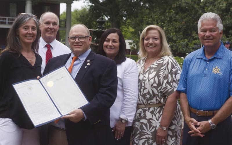 Sabrina Schmidt receives a State Legislature Proclamation from Louisiana Representative Mike Bayham during St. Bernard Day at the Capitol. Sharing the moment was Sabrina Schmidt, Judge William McGoey, Rep. Mike Bayham, Assessor Jay Lynn Turner, Judge Kim Jones, and Sheri James Pohlmann.