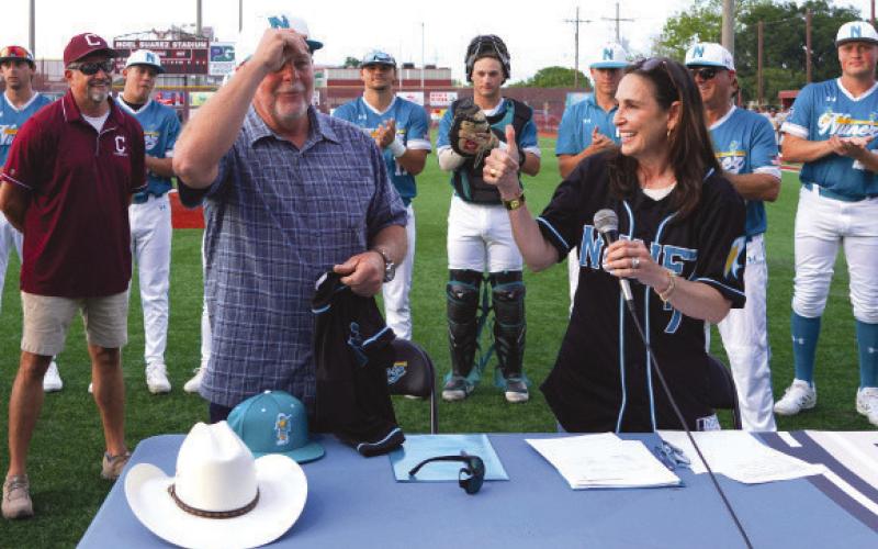 Parish President Louis Pomes trades his signature cowboy hat for a Nunez Baseball hat after joining Nunez Chancellor Tina Tinney in signing a land donation agreement that transfers ownership of a tract of land on De La Ronde Drive to Nunez to serve as the future site of Nunez Baseball’s home stadium. Behind them, Nunez Baseball Coach Glenn Powell, Chalmette High Baseball Coach Jason Tucker and Nunez Baseball players look on.